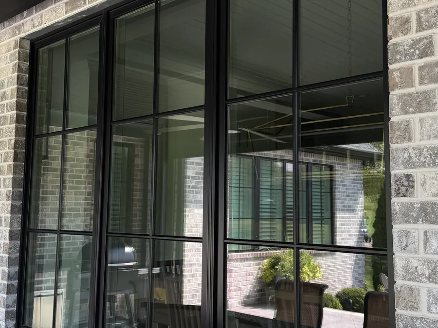 Clean black-framed windows on a brick home, Nashville window cleaning