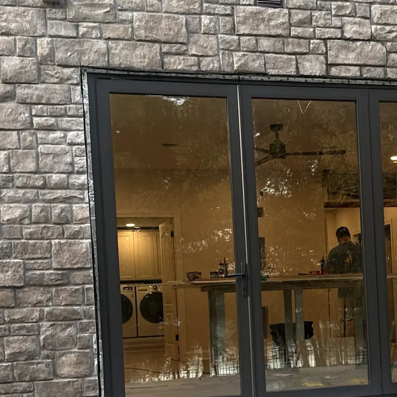 Clean folding glass doors on a stone home