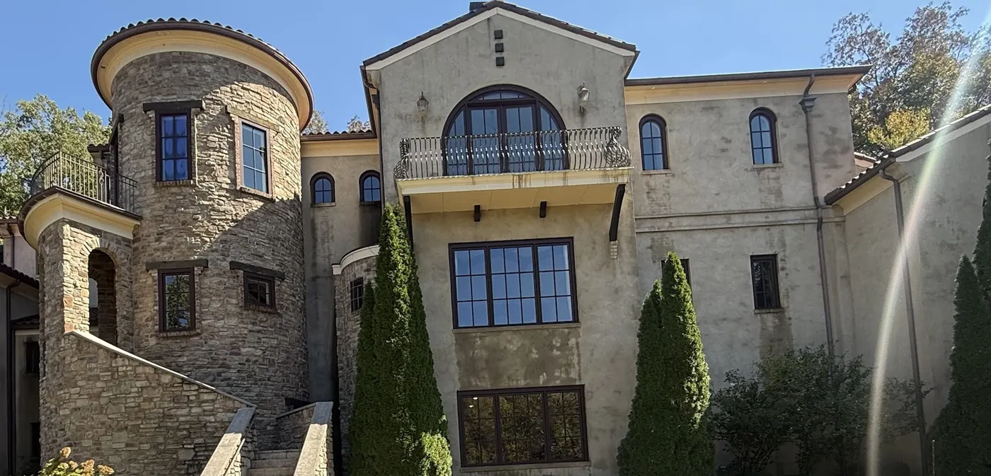 Stone and stucco estate with arched windows, Lucent window cleaning project